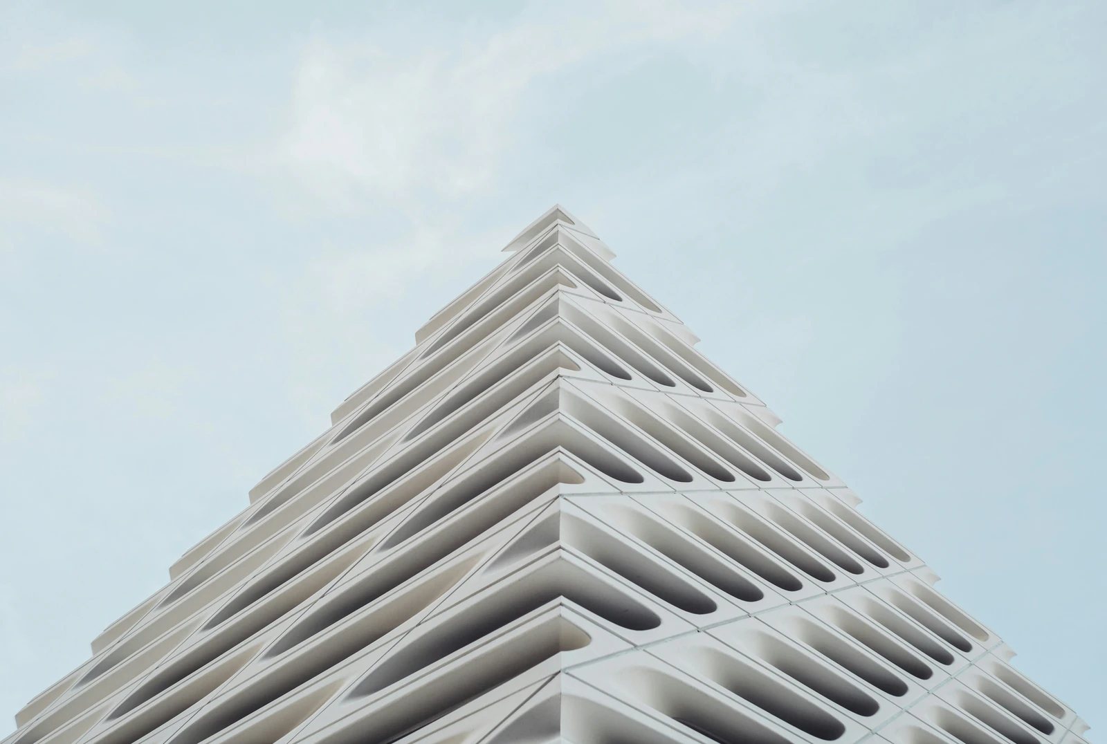 White geometric architecture against a pale blue sky